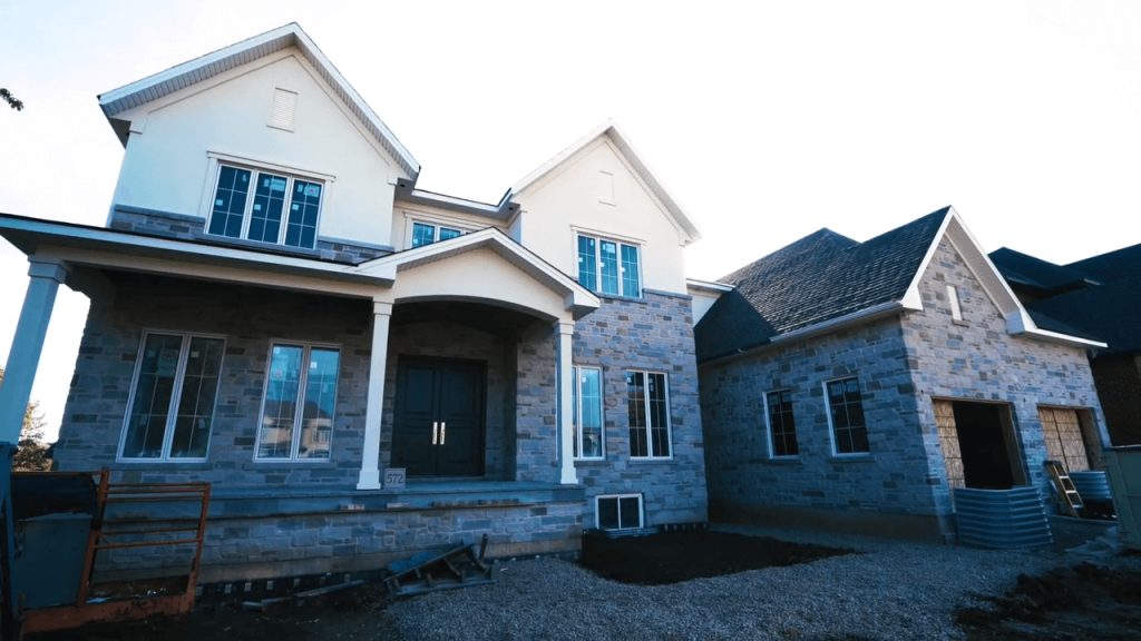 The front of a newly constructed brick home and garage in Grimsby, Ontario.