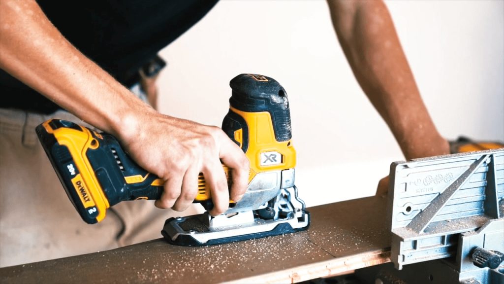 A carpenter cutting a piece of hardwood flooring with a DeWalt saw in Grimsby, Ontario.